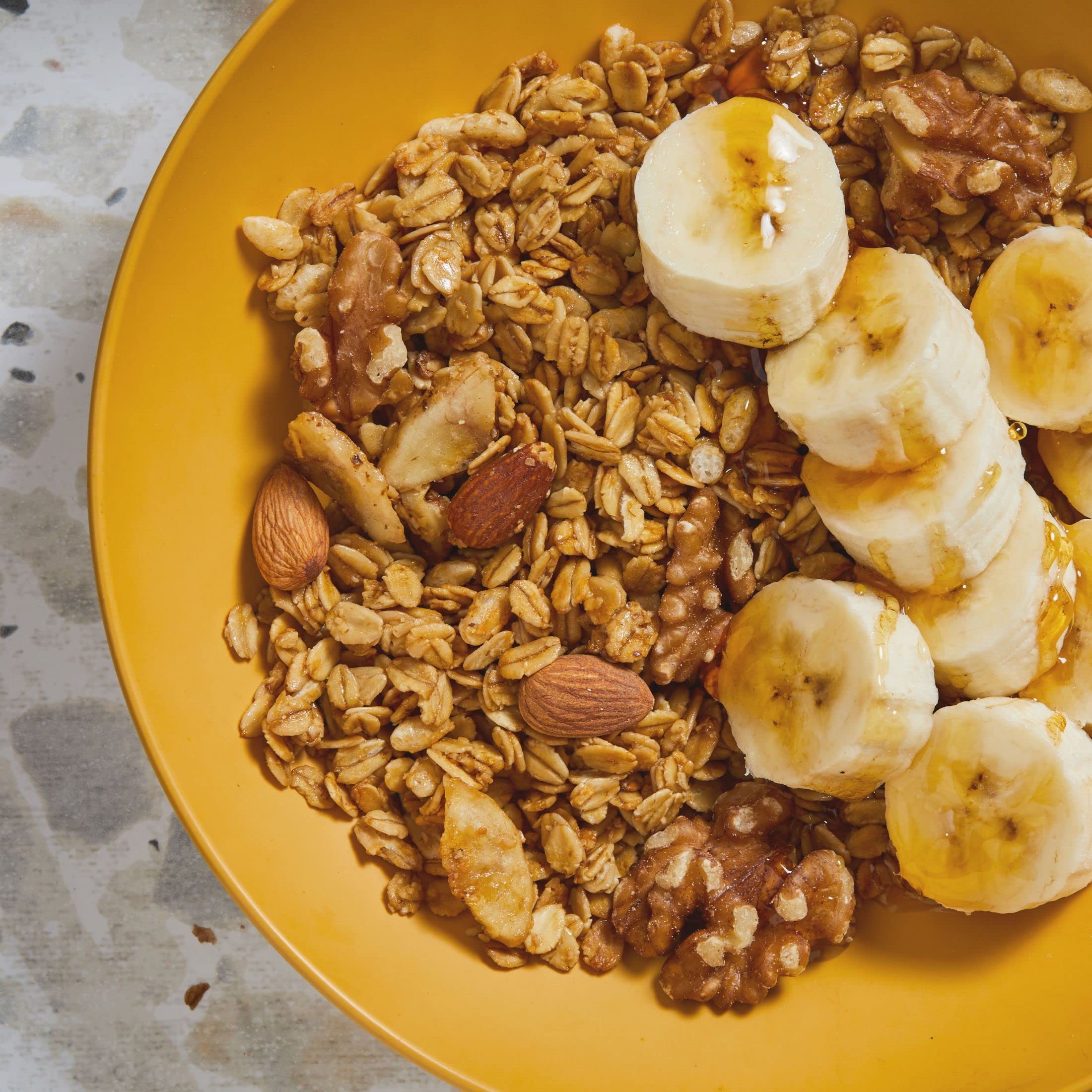 Kellogg's Bear Naked Banana Nut granola almonds and walnuts close-up, crunchy texture.