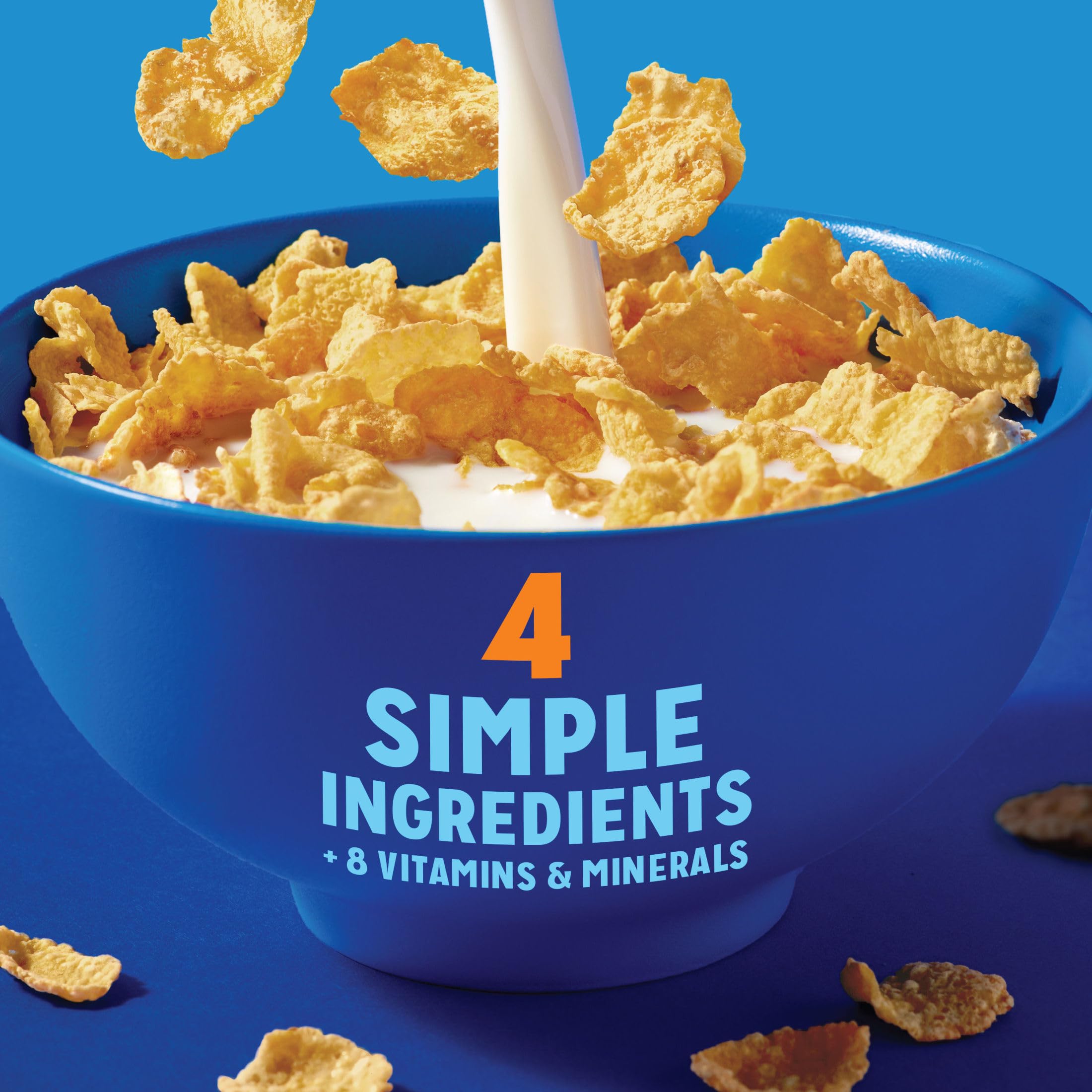 Milk poured over Kellogg's Frosted Flakes 25% Less Sugar for a creamy bite.