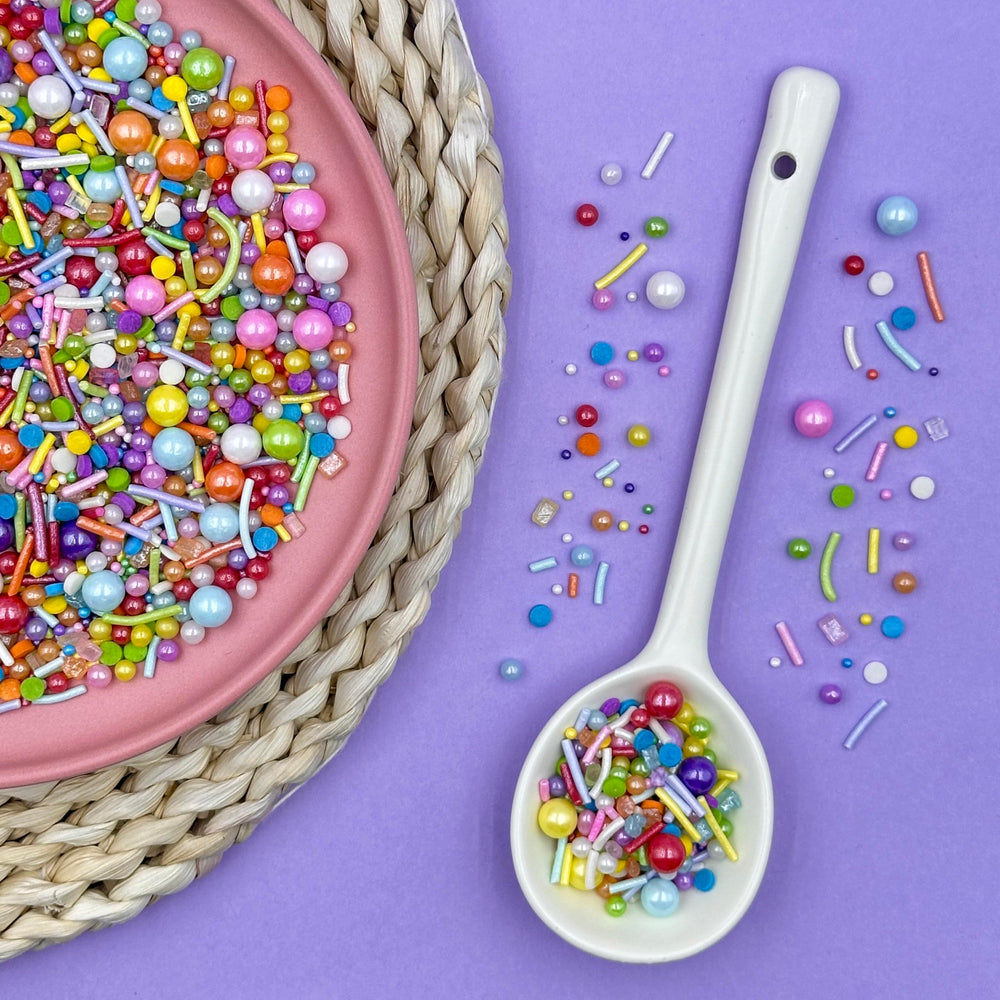 Kercky Rainbow Sprinkles on cake for colorful decoration.