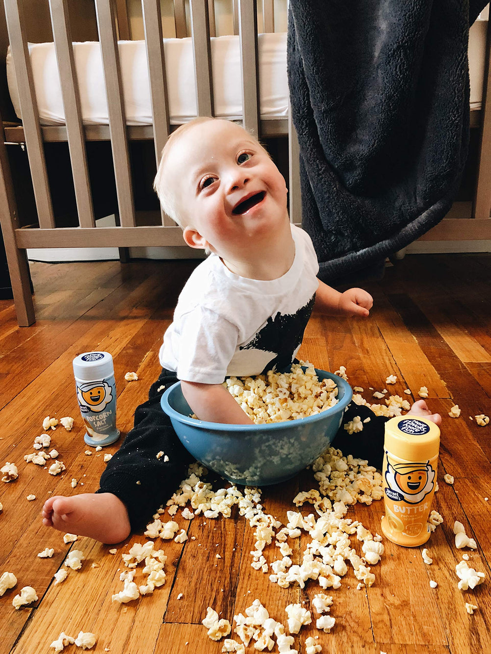 Pouring Kernel Season's Butter seasoning over popcorn for even coverage