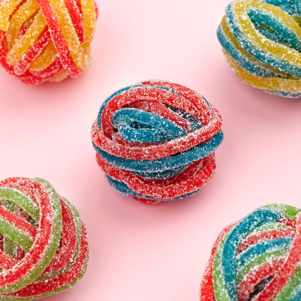 Kervan Bebeto Rainbow Laces displayed at a dessert table for a colorful buffet.