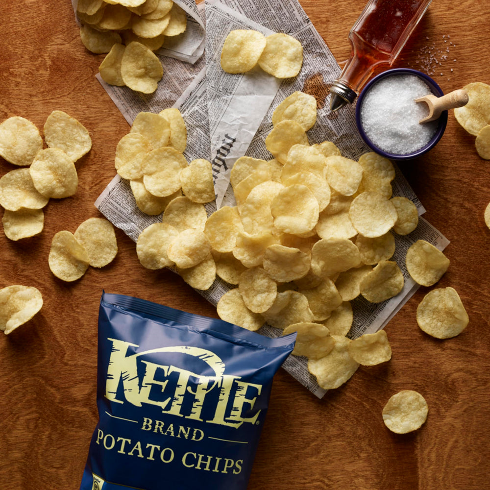 Kettle Brand Salt & Vinegar chips in hand for portable snacking