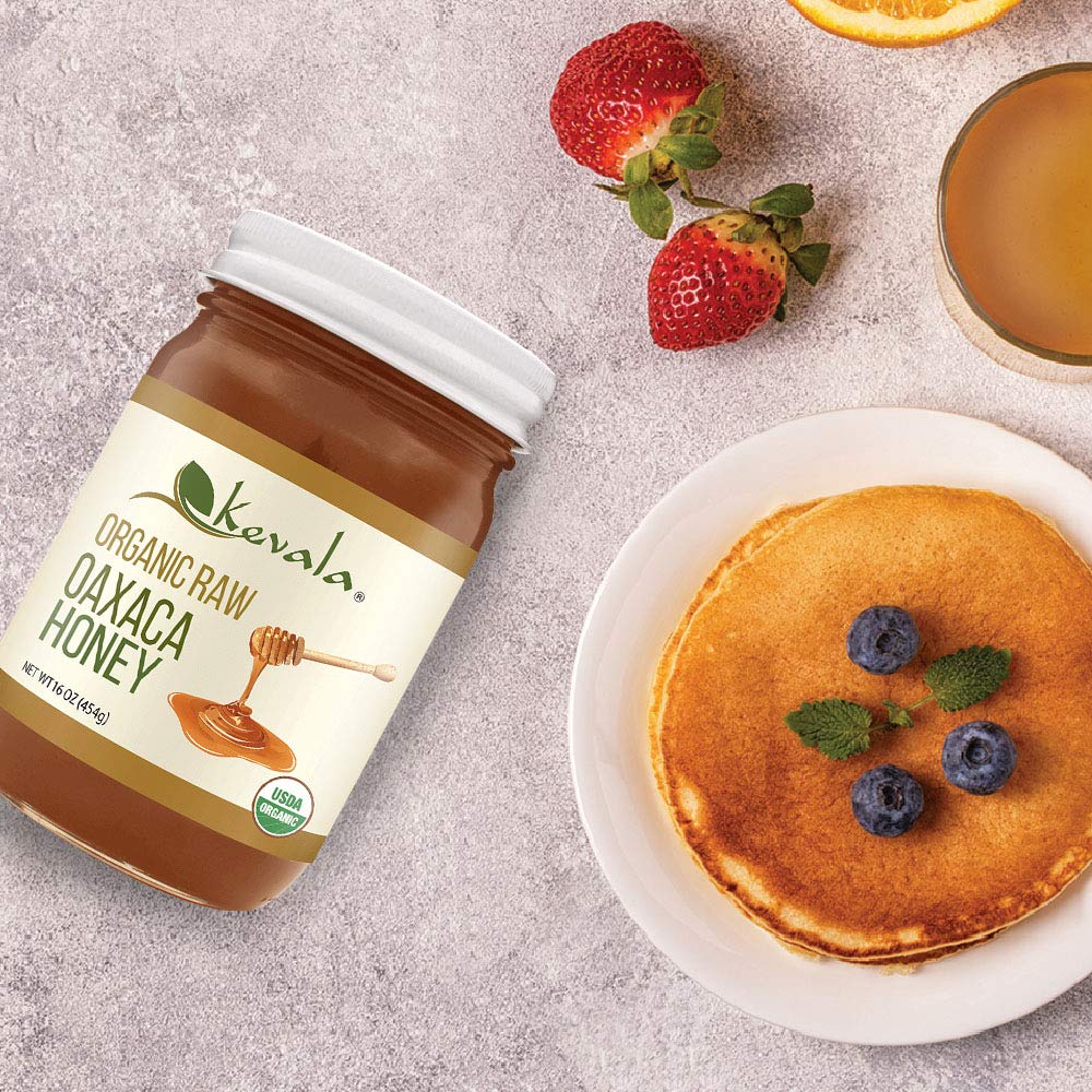 Kevala honey drizzled from a glass jar for natural sweetness.