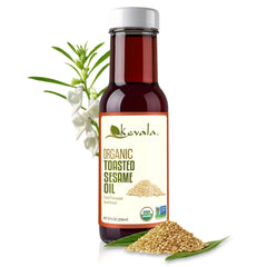 Kevala toasted sesame oil bottle pour with nutty aroma for savory stir-fries.