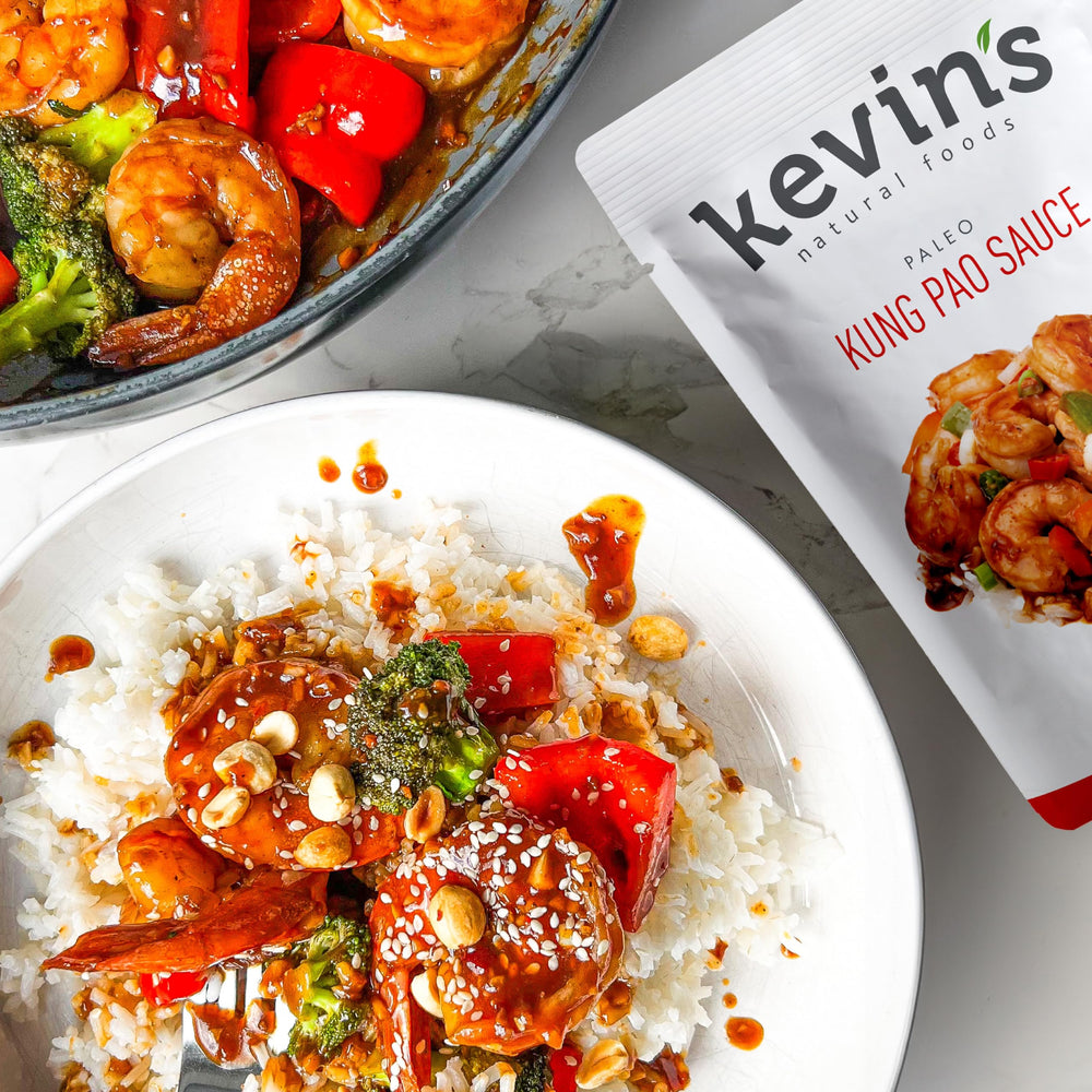 Kevin's Natural Foods honey garlic simmer sauce bottle—sweet-savory glaze for proteins.