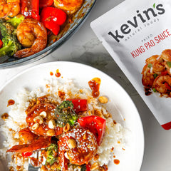 Kevin's Natural Foods honey garlic simmer sauce bottle—sweet-savory glaze for proteins.