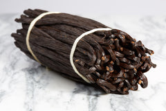 Kiddu vanilla beans closeup crystals highlight vanillin richness for flavor potential.