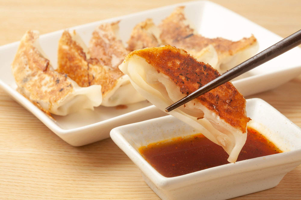 Kikkoman Gyoza Dipping Sauce served with grilled shrimp or steak for flavor boost