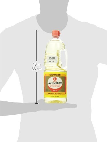 Kikkoman Manjo Aji Mirin bottle with herbs and spoon.