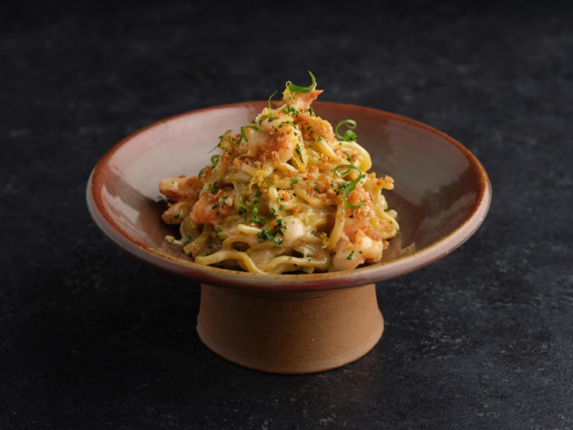 Kikkoman Ponzu pour action showing tangy glaze to enhance seafood.