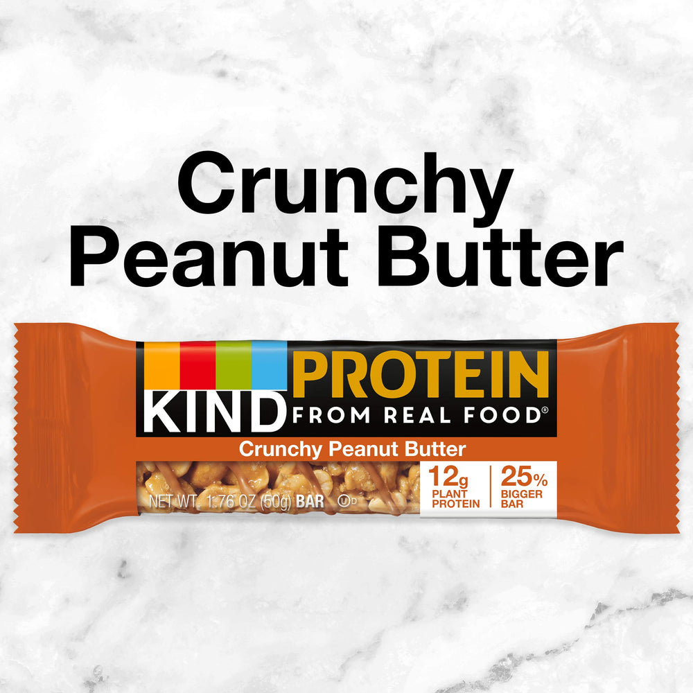 KIND PROTEIN Crunchy Peanut Butter bar in hand shows portable energy