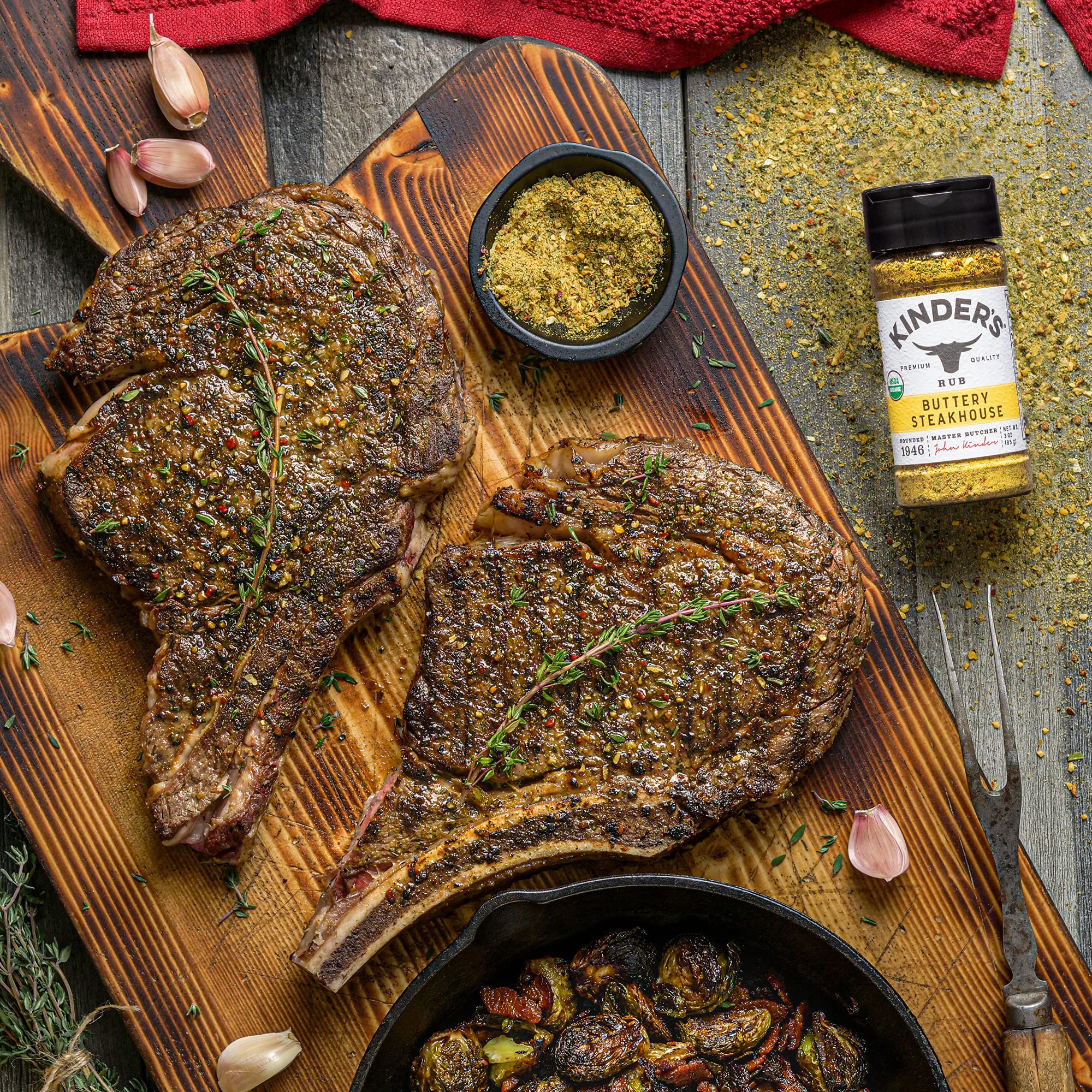 Kinder's Buttery Steakhouse Rub spice jar on cutting board; ideal for beef marinade