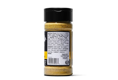 Sprinkling Kinders seasoning over meat before cooking for enhanced flavor.