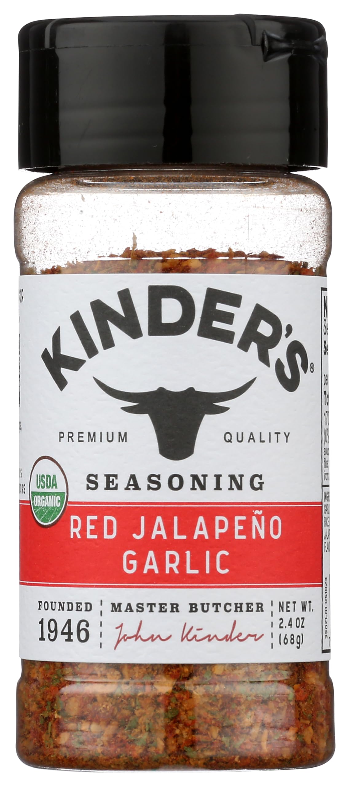KINDER'S Organic Red Jalapeño & Garlic seasoning bottle on kitchen counter for bold flavor.