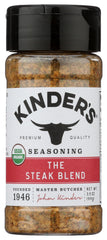 KINDER'S organic steak blend seasoning bottle on grill, ready for use.