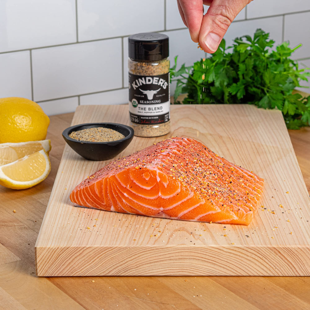 Grill-ready Kinder's The Blend on chicken for flavorful searing.