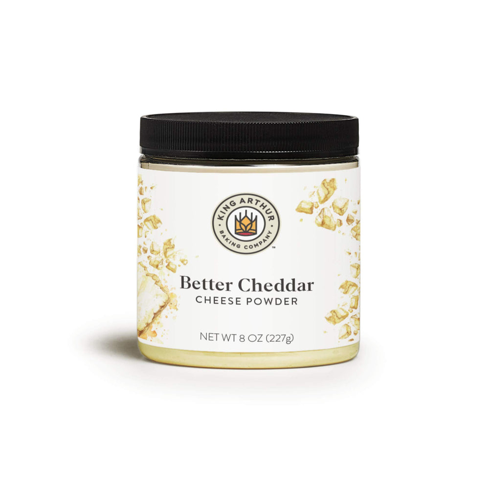 King Arthur Better Cheddar Cheese Powder jar close-up highlighting premium cheddar flavor for snacks and sauces.