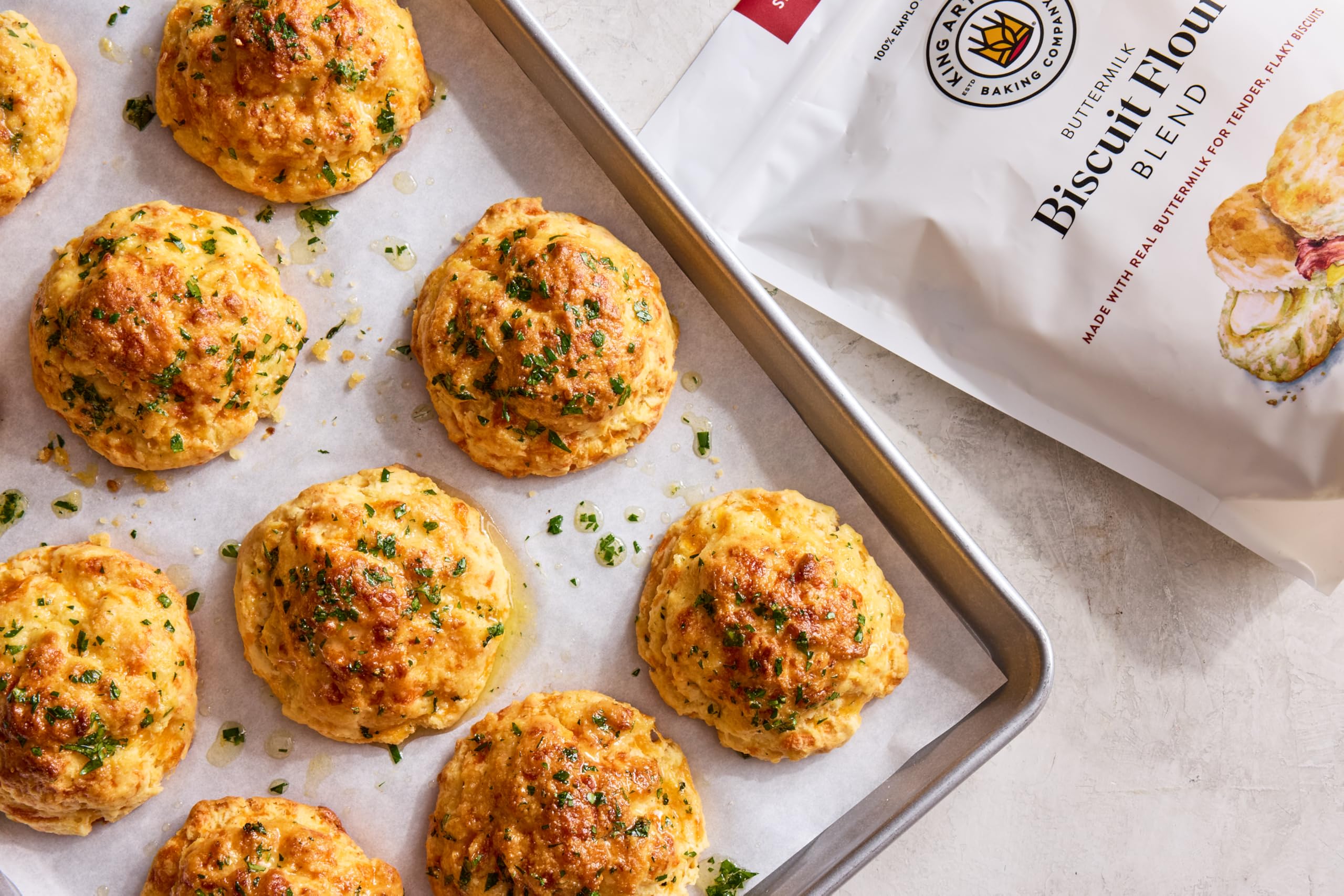 Measuring and mixing King Arthur Biscuit Flour Blend, versatile base for add-ins.