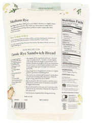King Arthur Organic Medium Rye Flour in a measuring cup for precise mixing at home.