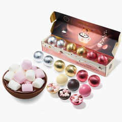 Kiri & Sons marshmallow-filled white chocolate bomb melting in hot milk for a creamy cocoa