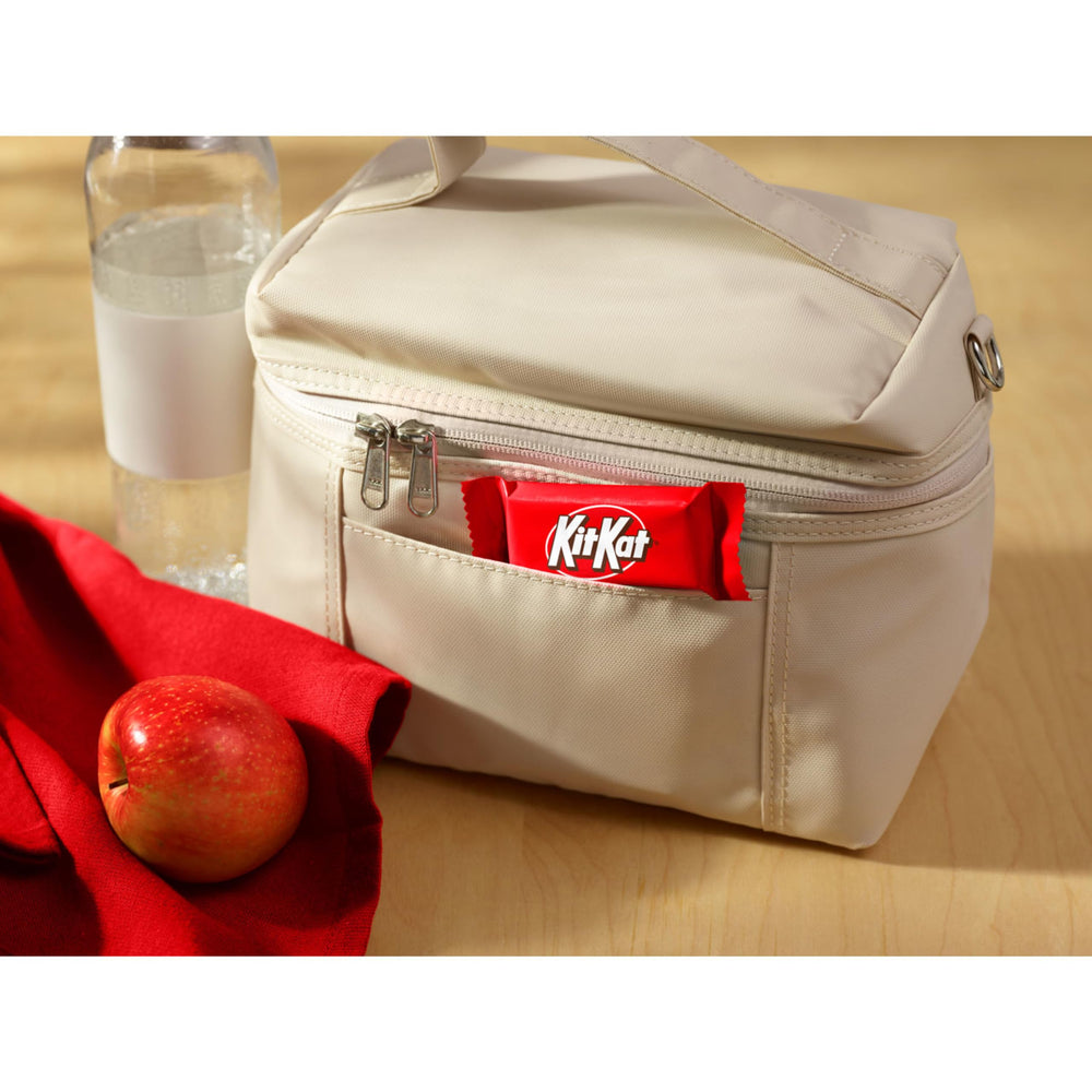 Kit Kat crisp wafer in creamy milk chocolate for a satisfying bite.