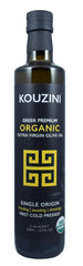 Kouzini olive oil bottle on kitchen counter, premium single-origin Greek EVOO for cooking.