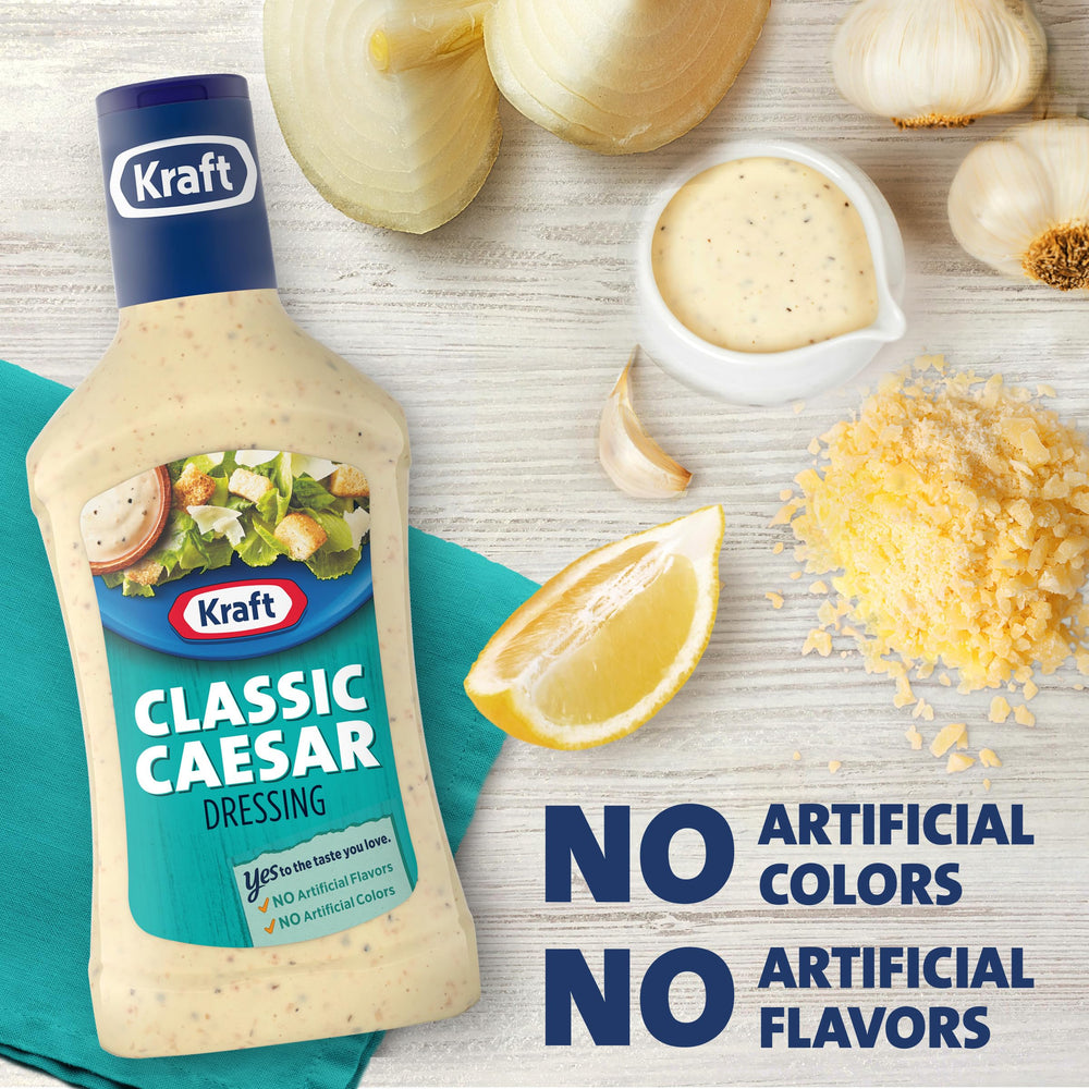Kraft Caesar dressing creamy texture on spoon, ready for dipping.