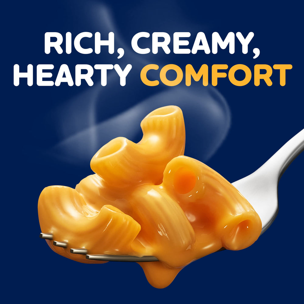 Happy family enjoying Kraft Deluxe Mac and Cheese at the table