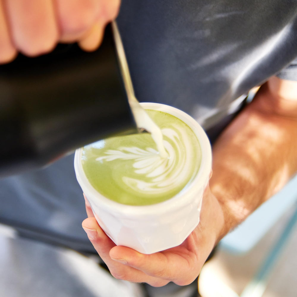 Kuli Kuli Mo Matcha Moringa Latte setup with mug and spoon for easy brewing