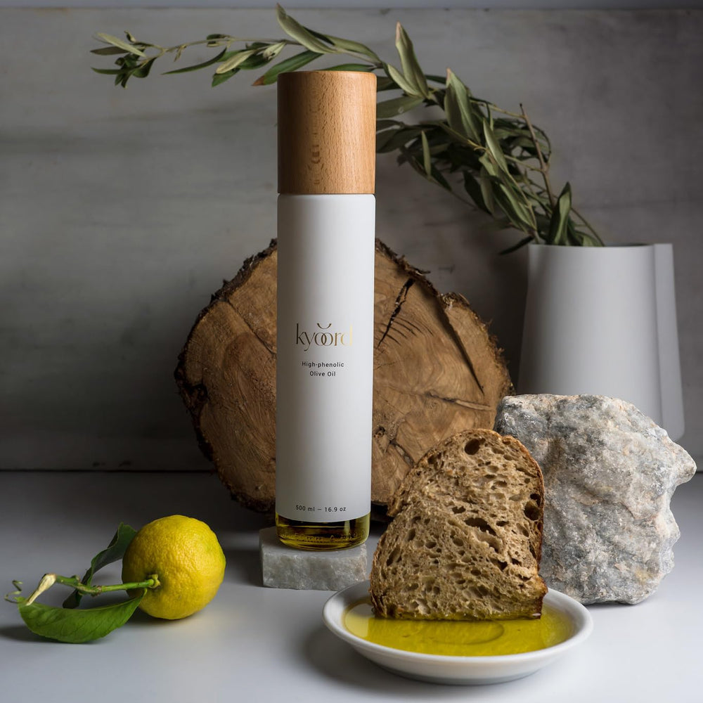 Kyoord High-Phenolic Olive Oil pour bottle mid-pour for finishing dishes