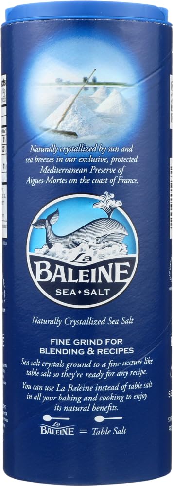 Pouring La Baleine sea salt canister for controlled, even seasoning.