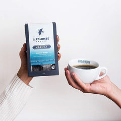 Steam rising from a Corsica dark roast cup revealing a rich flavor