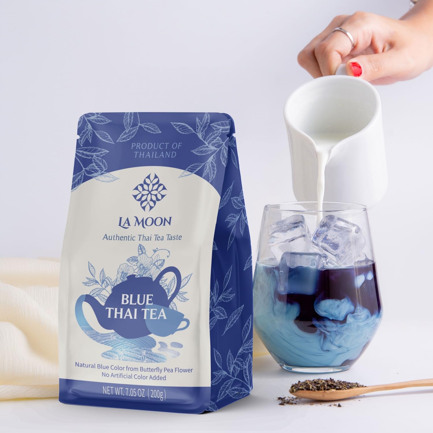 LA MOON TEA Blue Thai Tea mix being poured into a glass for iced tea