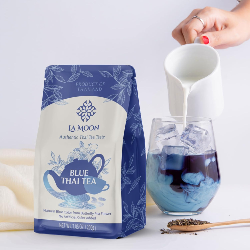 LA MOON TEA Blue Thai Tea mix being poured into a glass for iced tea