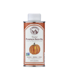La Tourangelle toasted pumpkin seed oil bottle on a kitchen shelf for gourmet flavor.