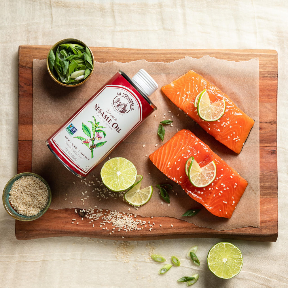 La Tourangelle Toasted Sesame Oil with measuring spoon, ideal for precise flavor balance.
