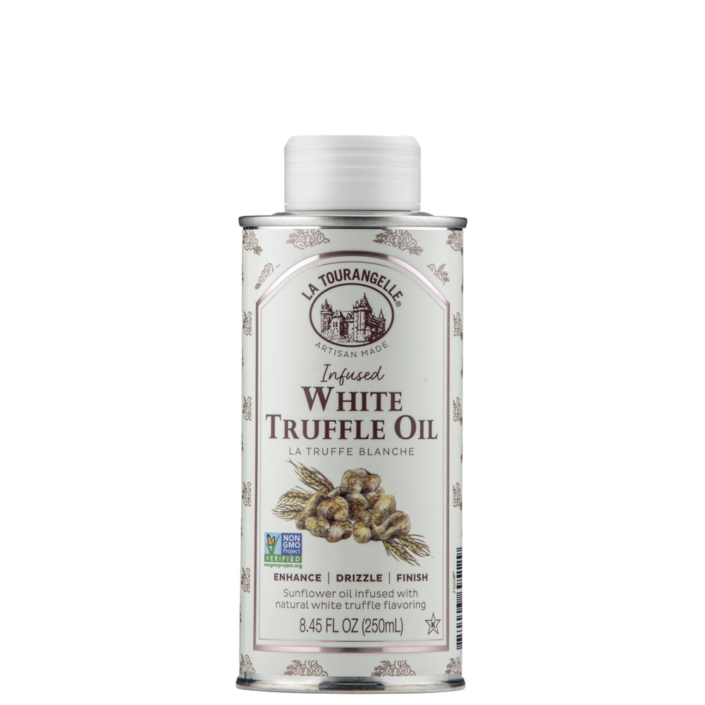 La Tourangelle White Truffle Oil bottle being poured over pasta for finishing touch.