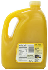 Pouring Langers Mango Nectar into a glass for refreshment.