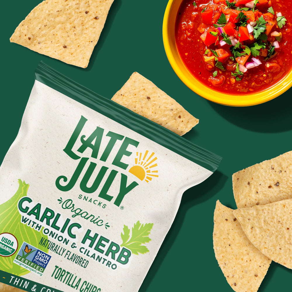 Plate of Late July Garlic Herb Tortilla Chips with cilantro and onion notes.