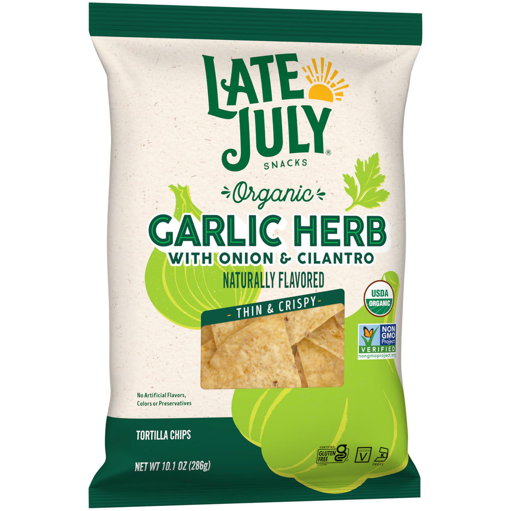 Party table with Late July Garlic Herb Tortilla Chips and dips.