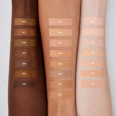 Swatches of Laura Mercier Real Flawless serum concealer on skin showing natural shade match.