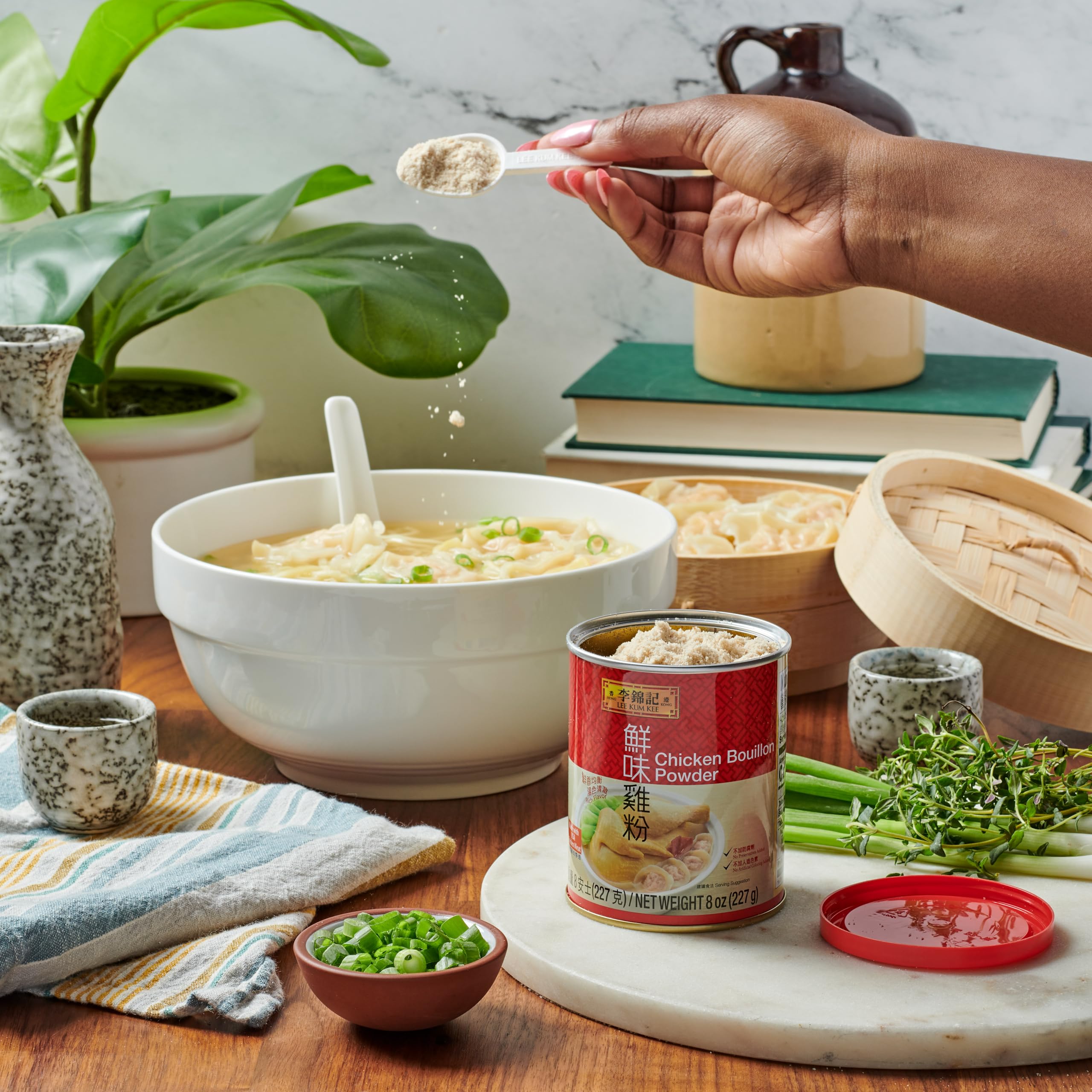 Lee Kum Kee Chicken Bouillon Powder closeup scoop enables savory base building.