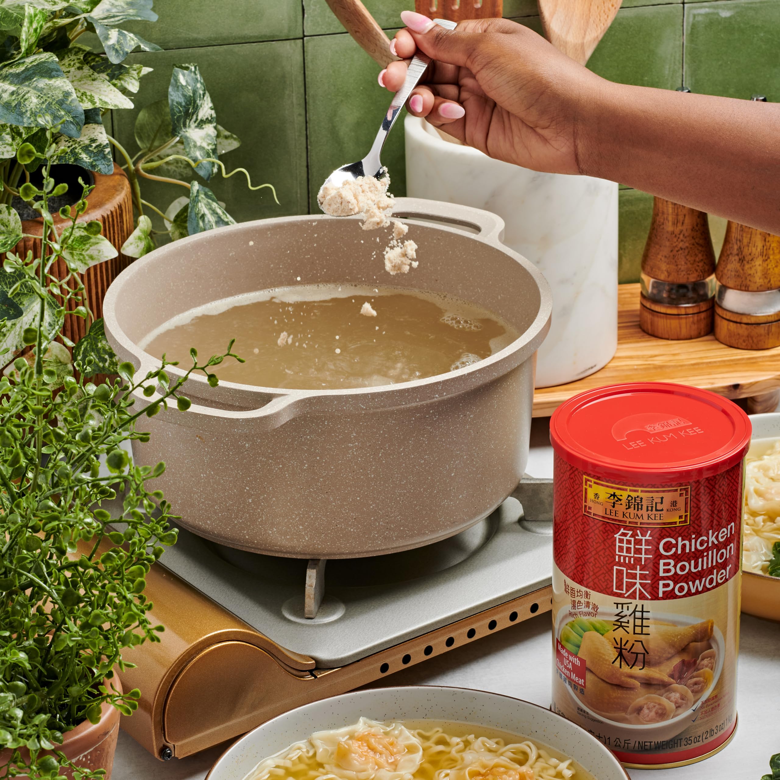 Warm steam rises from a soup pot with Lee Kum Kee seasoning.