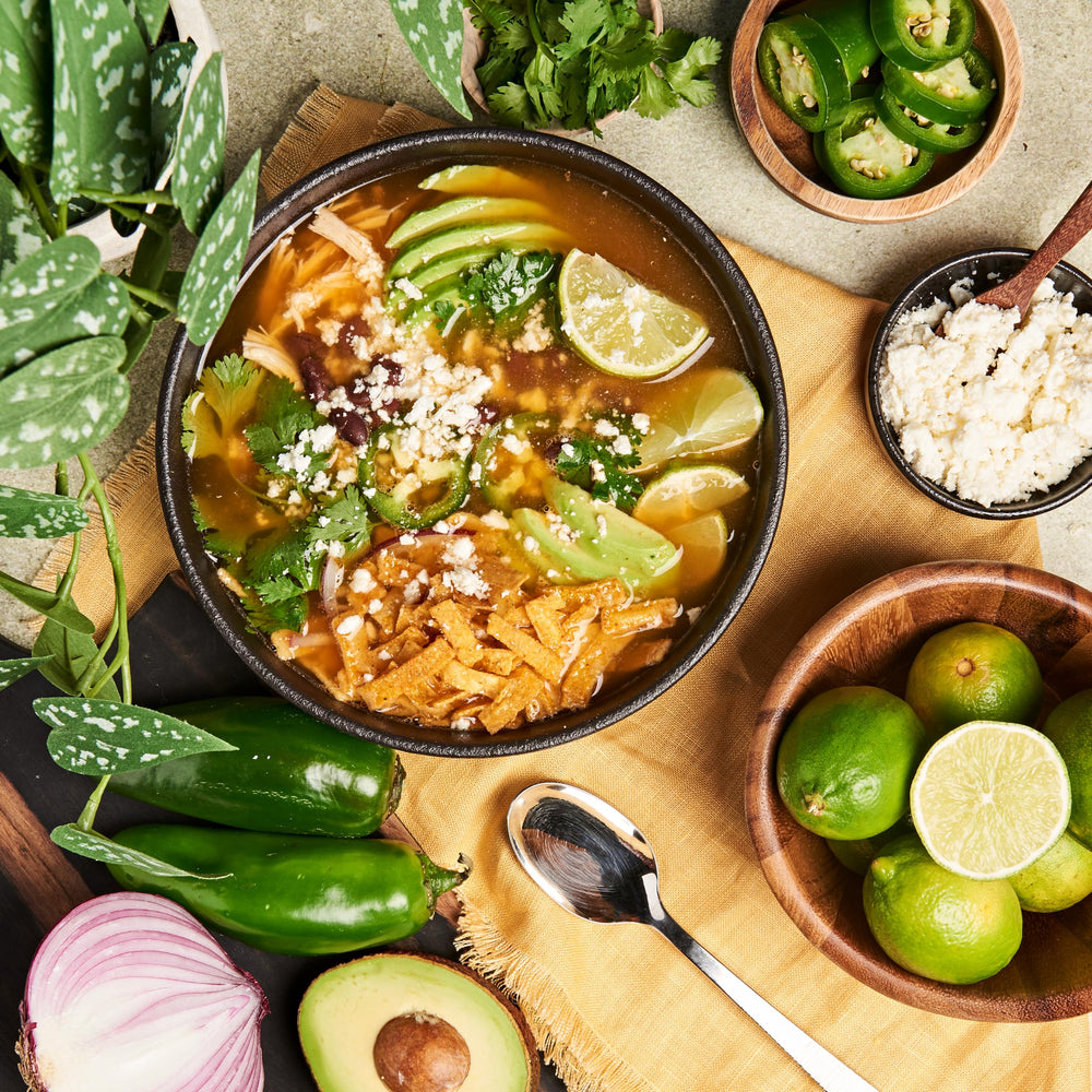 Lee Kum Kee chicken powder stirred into simmering broth