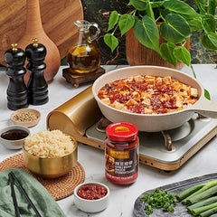 Lee Kum Kee Chili Bean Sauce in a stir-fry pan adds depth to proteins and vegetables.
