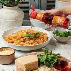 Lee Kum Kee Chili Oil is poured to showcase silky texture and fiery aroma for noodles.
