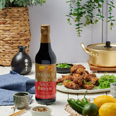 Close-up pour of Lee Kum Kee Premium Light Soy Sauce over vegetables for savory flavor