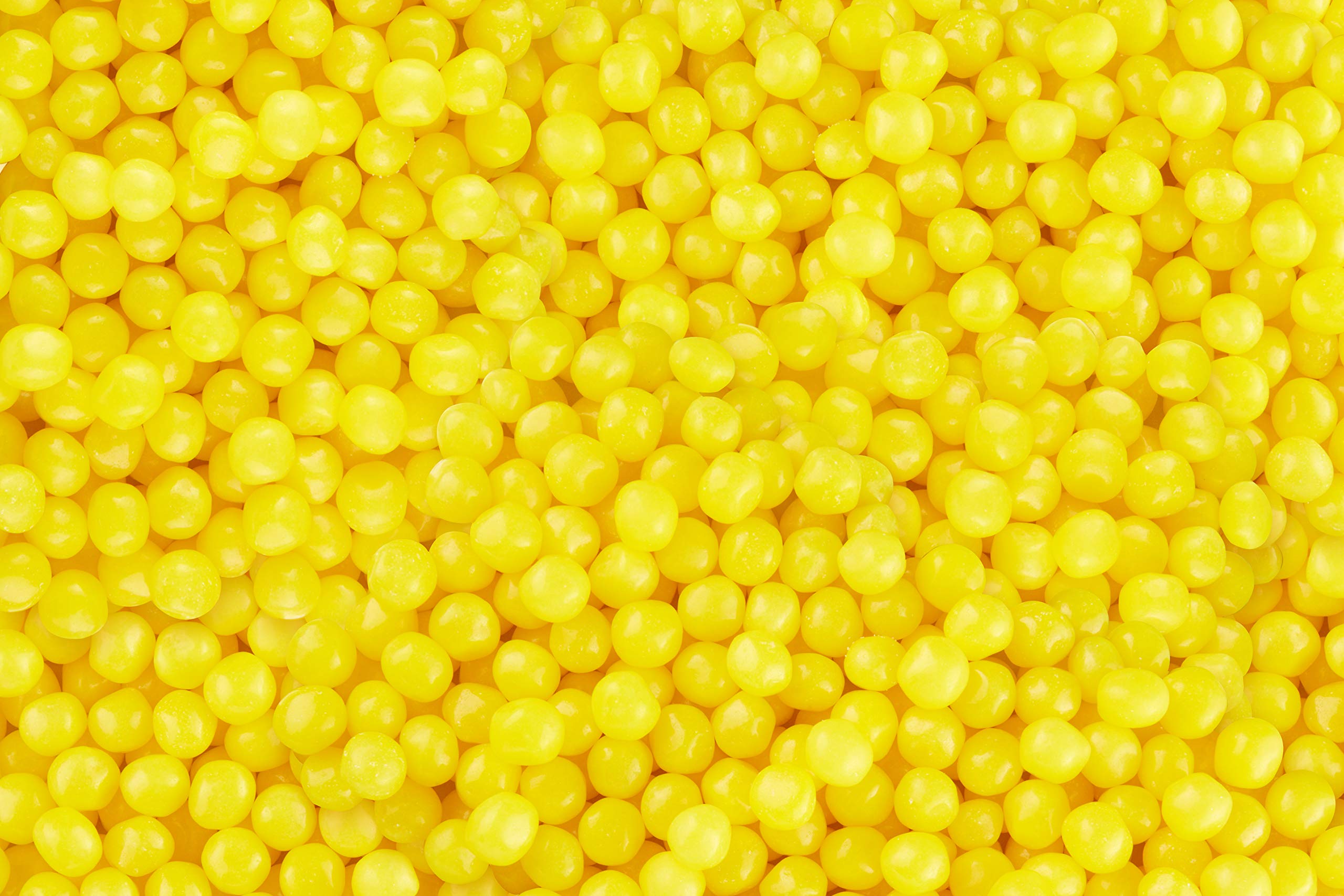 Lemonhead movie-night snack setup with bright yellow candy enjoyed with popcorn.