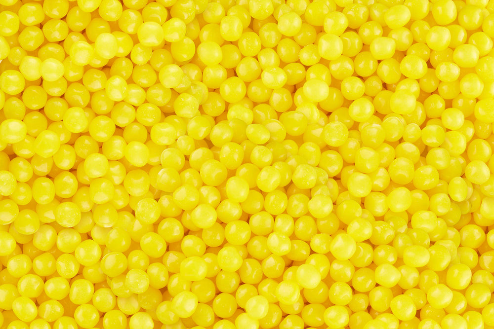 Lemonhead movie-night snack setup with bright yellow candy enjoyed with popcorn.