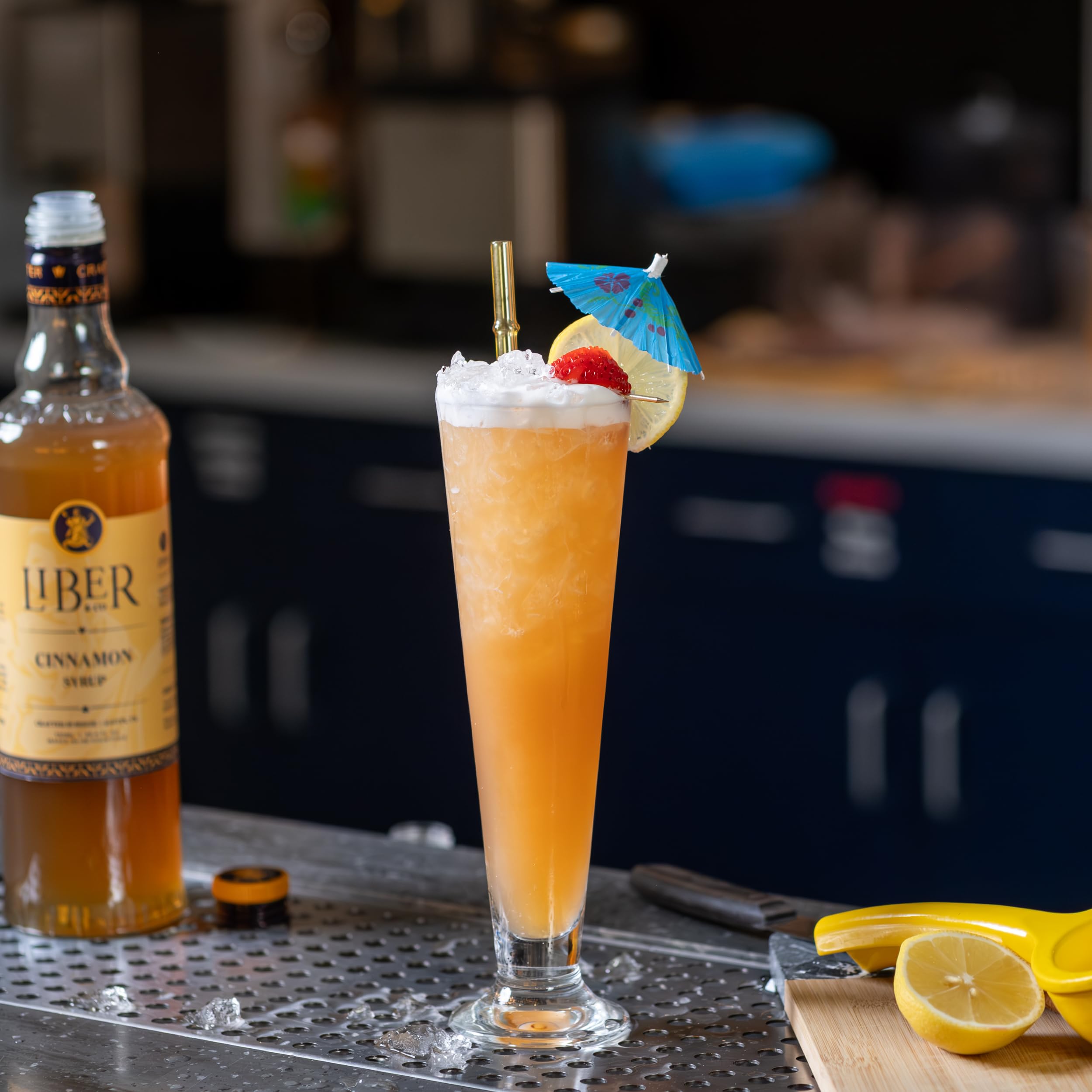 Home bartender pours Liber & Co. syrup into glass.